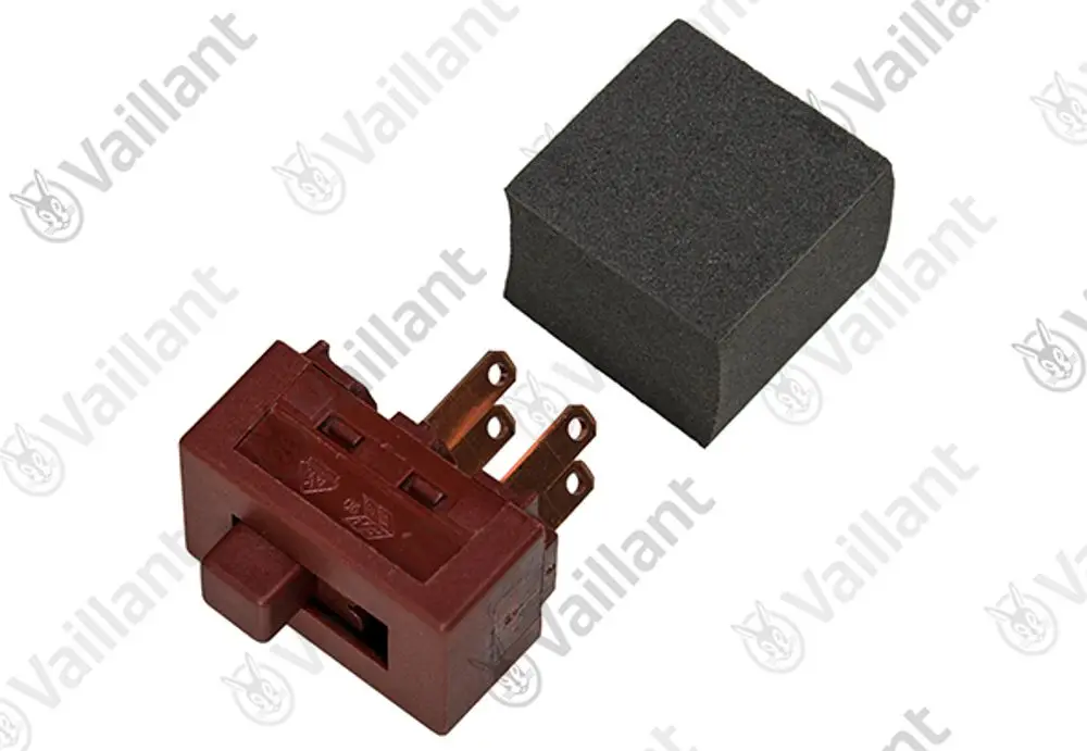 Vaillant Schalter in roter Ausführung mit mehreren Anschlussklemmen und einem schwarzen Schaumstoffblock daneben.